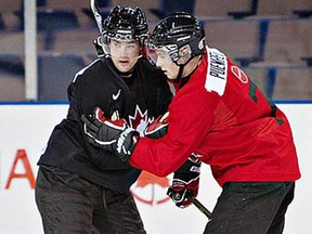 Essex native Matt Puempel, right, is checked by Kitchener's Ryan Murphy at the Canadian National Junior team summer development camp in Edmonton last year/ (Jason Franson/Edmonton Journal)