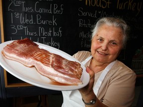 Anna Dragicevic of Lad's Dairy Bar on Tecumseh Road East holds a plate of bacon used for their popular breakfast dishes Wednesday September 26, 2012. There may be a shortage of pork in the future causing prices to skyrocket.  (NICK BRANCACCIO/The Windsor Star)