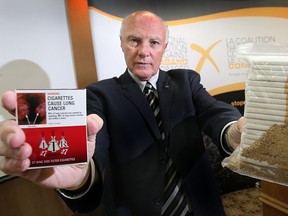 Gary Grant, spokesperson for the National Coalition Against Contraband Tobacco organization displays contraband cigarettes at a news conference. (DAN JANISSE/The Windsor Star)