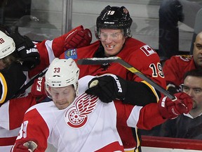 Blair Jones of the  Calgary Flames takes exception to being shoved into the boards by Jan Mursak  of the Detroit Red Wings during the first period at Calgary's Saddledome on Jan.31, 2012.  (Ted Rhodes/Calgary Herald)