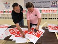 CAW union strike marshals Scott Richardson, left,  and Sandra Dominato prepare strike signs on Friday, Sept. 14, 2012, at  Local 173 hall in Windsor. Members are preparing for a possible strike Monday if contract talks fail. (DAN JANISSE/The Windsor Star)