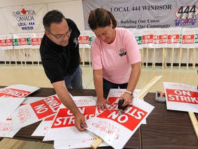 CAW union strike marshals Scott Richardson, left,  and Sandra Dominato prepare strike signs on Friday, Sept. 14, 2012, at  Local 173 hall in Windsor. Members are preparing for a possible strike Monday if contract talks fail. (DAN JANISSE/The Windsor Star)