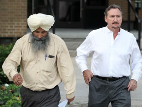 Karamjit Singh Grewal, 48, left, of Brampton Ont., walks out of Superior Court with his lawyer, Patrick Ducharme, on Sept. 17, 2012.  (DAX MELMER/The Windsor Star)