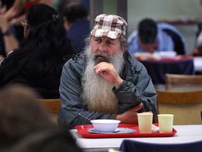 The Downtown Mission in Windsor, Ont. is celebrating its 40th anniversary. A visitor to the mission eats lunch Tuesday, Sept. 18, 2012, at the facility.   (DAN JANISSE/The Windsor Star)