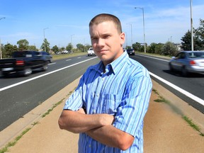 Brandon Watt poses Wednesday, Sept, 12, 2012, near the EC Row Expressway in Windsor, Ont. He has a suggestion that might alleviate congestion on the highway. (DAN JANISSE/The Windsor Star)