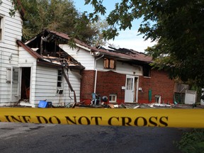 Yellow police tape surrounds the scene of an early morning house fire at 216 Richmond Street in Amerherstburg, Ont., where two people died, Sept. 9, 2012. (DAX MELMER/The Windsor Star)