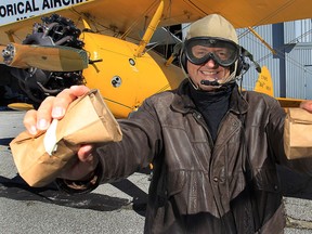 Windsor Star reporter Doug Schmidt displays flour packets that he dropped Wednesday, Sept. 19, 2012, from a Boeing Stearman plane. (DAN JANISSE/The Windsor Star)