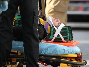 WINDSOR, ONT.:SEPTEMBER 22, 2012 -- A woman is tended to by emergency personnel after a motor vehicle accident between a Ford Taurus GL and a Pontiac Vibe at the intersection of Hanna Street West and Dougall Avenue, Saturday, Sept. 22, 2012.  (DAX MELMER/The Windsor Star)