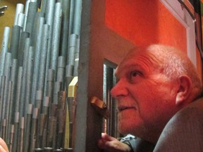 Organist Paul Wharram peeks into the organ chamber at Church of the Epiphany in Kingsville Tuesday. A new organ console is being installed at the historic church today.  (Sarah Sacheli/The Windsor Star)