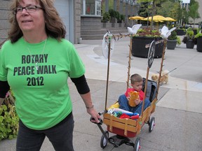 A local Rotarian with cargo in tow sets off on the Rotary Peace Walk, Friday, Sept. 21, 2012. (BEATRICE FANTONI/The Windsor Star)