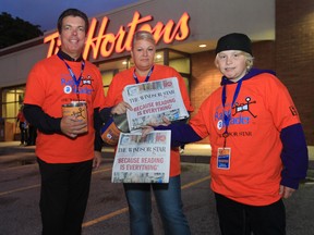 Windsor Star Pubisher Marty Beneteau, left, Angela Meloche and Carson Meloche take part in last year's Raise A Reader fundraiser. (JASON KRYK/ The Windsor Star)