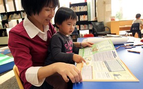 Alana Yu gets some help from her mother Lijuan Zhang while reading at the downtown library branch in Windsor on Tuesday, September 11, 2012. (TYLER BROWNBRIDGE/The Windsor Star)