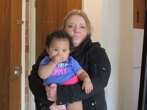Olivia Blackburn, 20, and daughter, Ella, 10 months, were forced out of their rented Leamington apartment Tuesday by a flood caused by a leaking roof and windows (SARAH SACHELI/The Windsor Star).