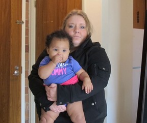 Olivia Blackburn, 20, and daughter, Ella, 10 months, were forced out of their rented Leamington apartment Tuesday by a flood caused by a leaking roof and windows (SARAH SACHELI/The Windsor Star).