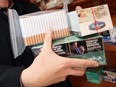 Peter Seemann, Ontario's regional co-ordinator for the CCSA, hold examples of contraband cigarettes during a press conference at the Super Plus convenience store in Amherstburg in Nov. 2010. (TYLER BROWNBRIDGE / The Windsor Star)