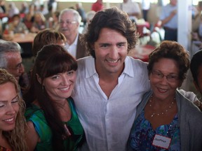 MP Justin Trudeau, centre, poses for photographs with people attending the Windsor-Essex Liberal BBQ at the Ciociaro Club, Saturday, Sept. 8, 2012. (DAX MELMER/The Windsor Star)