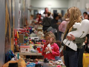 Chloe Soulliere, 7, and her mother, Brandy Soulliere, browse through the various items on sale at the Walkerville for Africa yard sale, at Walkerville Collegiate Institute on Sept. 24, 2011.(DAX MELMER / The Windsor Star)