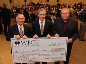 WINDSOR, ONTARIO - SEPTEMBER 13, 2012 -- From Left, Marty Komsa,  WFCU President and CEO,  Dr Alan Wildeman, University of Windsor President and Vice-Chancellor, and Marty Gillis, WFCU Chair of the Board, are all smiles as a the Windsor Family Credit Union hands over a donation of $500,000 towards the new Ed Lumley Centre for Engineering Innovation which will open to students on Monday September 17, 2012.   The cheque presentation took place Thursday evening during the Windsor Family Credit Union's 28th Annual General Meeting.  (JASON KRYK/ The Windsor Star)