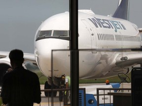 A WestJet plane rolls into Windsor International Airport  on Sept. 7, 2012. (DAN JANISSE/The Windsor Star)