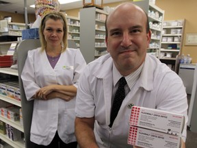 Pharmacists Sandy Kauric, left, and Gary Willard are ready with flu vaccine at Ziter Pharmacy on Howard Avenue, October 9, 2012.  (NICK BRANCACCIO/The Windsor Star)