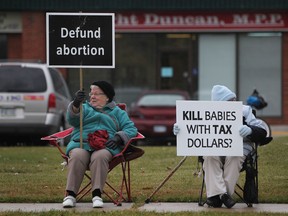 People demonstrate against the funding of abortions while outside the office of MPP Dwight Duncan on Lauzon Parkway Saturday, Oct. 13, 2012.  (DAX MELMER/The Windsor Star)