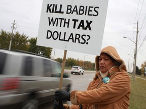 In this file photo, Anne Dosant protests the funding of abortions while outside the office of MPP Dwight Duncan on Lauzon Parkway Saturday, Oct. 13, 2012. (DAX MELMER/The Windsor Star)