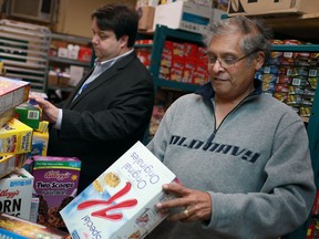 Downtown Mission director, development and community relations Ron Dunn, left, and executive director Chandra Dass sort through donated boxes of cereal, Saturday, Oct. 6, 2012. (DAX MELMER/The Windsor Star)