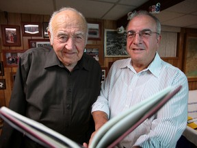 Angelo Nadalin and Paulo Savio, choir members of the Il Coro Italiano, leaf through a book written about the choir on its 40th anniversary, Sunday Oct. 7, 2012 at Savio's home in Windsor. After 50 years of performances the group is folding and will hold a final concert Nov. 4 at the Caboto Club. (KRISTIE PEARCE/The Windsor Star)
