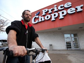 Cliff Miners, 47, is talks outside the Price Chopper on Crawford Avenue Sunday, Oct. 14, 2012 in Windsor. Miners relies on his bike for transportation and said the upcoming closure of the store will leave a grocery store void for west end residents. (Kristie Pearce/The Windsor Star)