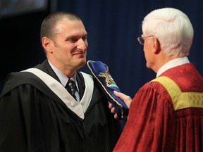 Essex MP, Jeff Watson, left, is recognized for receiving his degree from the University of Windsor during a convocation ceremony at the St. Denis Centre, Saturday, Oct. 13, 2012. (DAX MELMER/The Windsor Star)