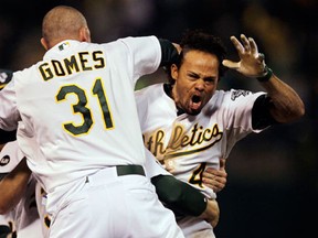 Oakland's Coco Crisp, right, celebrates after he hit a single to score Seth Smith and win the game 4-3 in the ninth inning of Game 4 of the American League division baseball series against the Detroit Tigers in Oakland Wednesday. (AP Photo/Ben Margot)