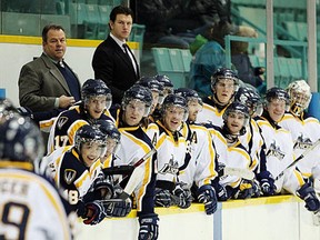 Lancers coach Kevin Hamlin, left, stands on the bench in a game against the Western Mustangs at Windsor Arena in 2011. (JASON KRYK/The Windsor Star)