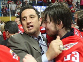 Spitfires coach Bob Boughner, left, hugs goaltender Philipp Grubauer after defeating the Barrie Colts 6-2 to win the Ontario Hockey League championship at the WFCU Centre in 2010. (JASON KRYK/The Windsor Star)