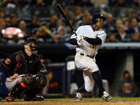 Ex-Tiger Curtis Granderson hits a home run in the seventh inning against the Orioles during Game 5 of the American League Division Series at Yankee Stadium Friday. (Elsa/Getty Images)
