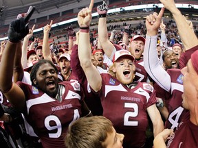 The McMaster Marauders celebrate their overtime win over the Laval Rouge et Or at the 2011 Vanier Cup final in Vancouver. (John Woods/Postmedia News)