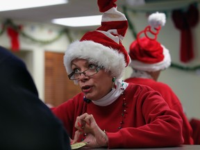 WINDSOR, ONTARIO - DECEMBER 16, 2011 --  Windsor Goodfellows volunteer Cherie Steele-Sexton was in the spirit while gathering information from a food basket recipient Friday December 16, 2011.  Windsor