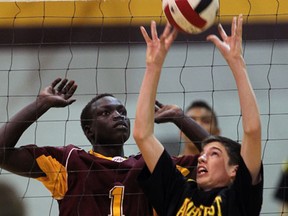 Catholic Central's Nyong James, left, prepares for a block as General Amherst's Dean Meunier sets the ball in WECSSAA volleyball action at Catholic Central. (NICK BRANCACCIO/The Windsor Star)