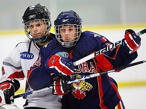 Southwest Wildcats' Jenna Jubinville, left, checks Terrie Jarvis of Aurora at Forest Glade Arena in 2010. (NICK BRANCACCIO/The Windsor Star)