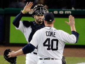 Detroit catcher Alex Avila, left, and Phil Coke celebrate at the end of Game 3 against the New York Yankees at Comerica Park. (AP Photo/Charlie Riedel)