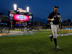 Members of the grounds crew put the tarp on the infield due to a weather delay for impending inclement weather prior to Game 4 of the American League Championship Series between the Detroit Tigers and the New York Yankees  at Comerica Park. (Leon Halip/Getty Images)