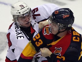 Windsor's Ty Bilcke, left, fights Erie's Connor Crisp during the Spits' 2-1 win at the WFCU Centre Thursdsay. (Jason Kryk/The Windsor Star)