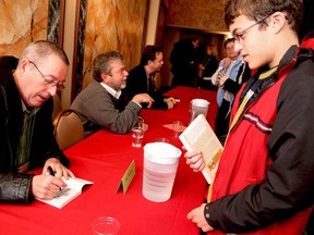 Mateo Price-Aguirre gets a book signed by author Eric Walters on Saturday, October 27, 2012 during BookFest Windsor 2012 held at the Capitol Theatre. Nearly 1,000 people attended the three-day event. The 12th annual festival featured over 40 authors with regional, national and international reputations. (REBECCA WRIGHT/ The Windsor Star)