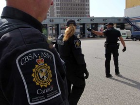 CBSA officers at Windsor Tunnel operations prepare to inspect a vehicle passing through booths Thursday October 4, 2012.  (NICK BRANCACCIO/The Windsor Star)