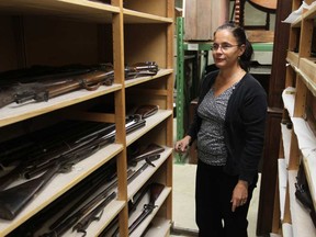 Madelyn Della Valle, curator at Windsor's Community Museum, displays a selection of historic firearms in the basement of the downtown Windsor museum on October 2, 2012.   (JASON KRYK/ The Windsor Star)