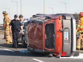 Police and fire officials investigate a rollover Tuesday, Oct. 16, 2012, on the EC. Row expressway. The accident occurred in the westbound lanes at approximately 3:00 p.m. Three people were taken away by ambulance with non-life threatening injuries.  (DAN JANISSE/ The Windsor Star)
