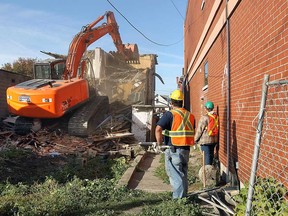 A home next to Drouillard Place is demolished to make way for a play area for the Early Years Program in Windsor, Ont. on Monday, October 1, 2012.           (TYLER BROWNBRIDGE / The Windsor Star)