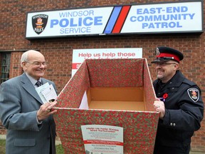 Dr. Norman King, left, and Sgt. Matt D'Asti launch a Windsor Police Service toy drive in association with community partners Windsor Homes Coalition and Windsor-Essex Children's Aid Foundation October 31, 2012.  (NICK BRANCACCIO/The Windsor Star)