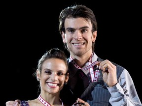 Pairs silver medalists Canada's Meagan Duhamel and Eric Radford show off their medals during victory ceremonies at Skate Canada International Saturday, October 27, 2012 in Windsor, Ont. (THE CANADIAN PRESS/Paul Chiasson)