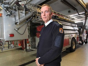Windsor city council on Monday will vote on a $4.3M request for four new aerial fire trucks for the Windsor Fire and Rescue Service. Chief Bruce Montone poses with one of the department's existing units Wednesday, Oct. 31, 2012, in Windsor, Ont.   (DAN JANISSE/The Windsor Star)