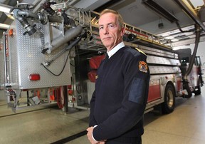 Windsor city council on Monday will vote on a $4.3M request for four new aerial fire trucks for the Windsor Fire and Rescue Service. Chief Bruce Montone poses with one of the department's existing units Wednesday, Oct. 31, 2012, in Windsor, Ont.   (DAN JANISSE/The Windsor Star)